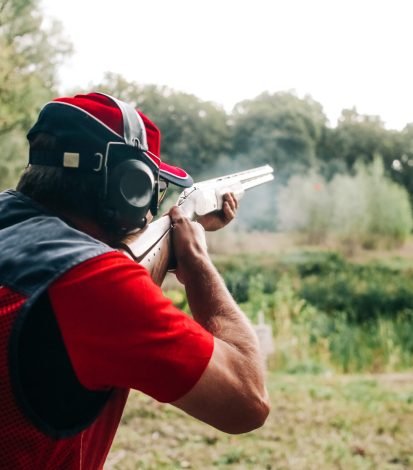 hunter shoots shotgun target special clothes headphones hunter shoots with a shotgun on a target in special clothes and headphones